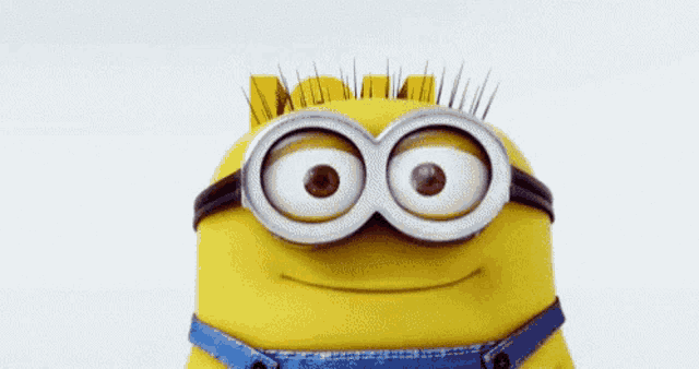 a close up of a minion wearing goggles and smiling