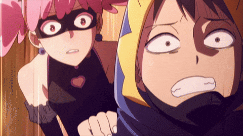 a girl in a mask stands next to a boy in a hood