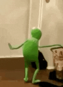 kermit the frog is dancing in a room with a rope around his waist .