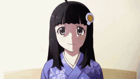 a girl with black hair and a flower in her hair is wearing a kimono and smiling .