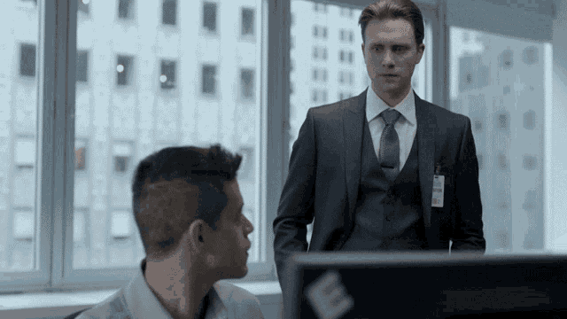 a man in a suit and tie has a name tag on his chest that says ' mr. '