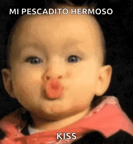 a baby is blowing a kiss with a red lipstick .