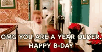 a person is standing in a living room with their arms outstretched and a birthday message .