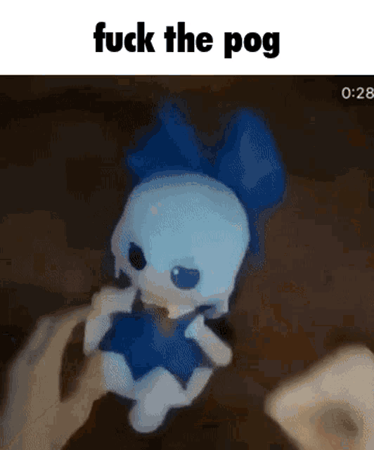 a person is holding a stuffed animal with the words `` fuck the pog '' on it .