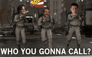 a group of ghostbusters are walking down a street with the words who you gonna call below them