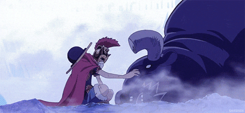 a man in a red cape is kneeling next to a monster in the water