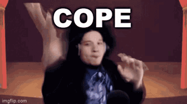 a man wearing headphones is dancing in front of a screen that says cope