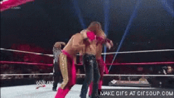 a wrestler is being thrown in the air by another wrestler .