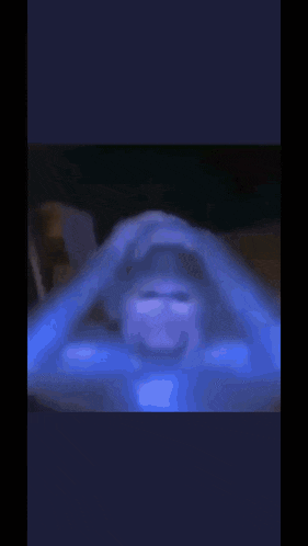 a blurry picture of a person holding their head with their hands