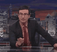 a man in a suit and tie is making a gesture