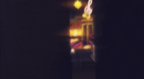 a man with white hair stands in front of a carnival ride at night