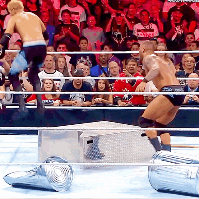 two men in a wrestling ring one of whom is wearing a canadian shirt
