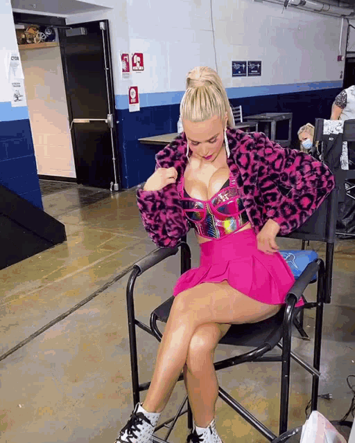 a woman sits in a chair with her legs crossed