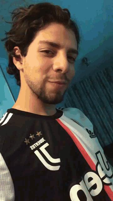 a man is wearing a black and white juventus shirt