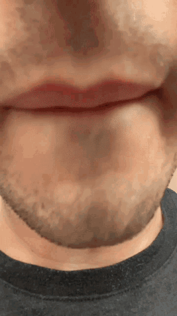 a close up of a man 's face with a beard