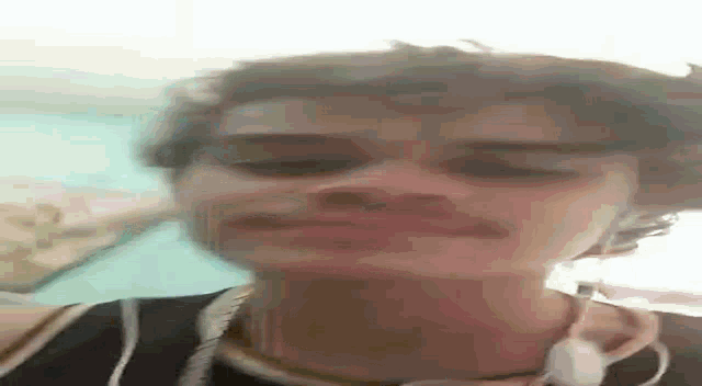 a close up of a person 's face with their eyes closed and their mouth open .