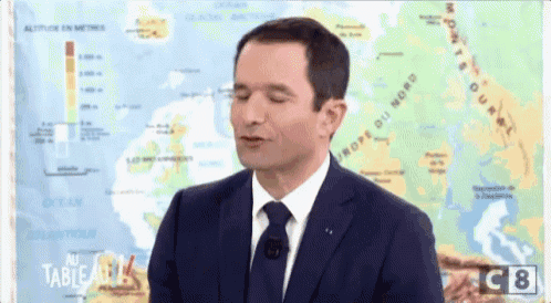 a man in a suit and tie is standing in front of a map that says altitude on it