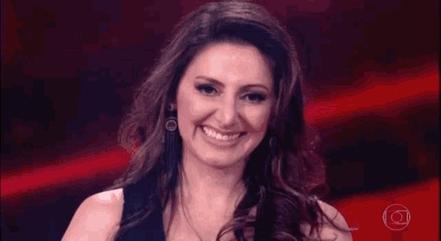 a woman is smiling while holding a microphone