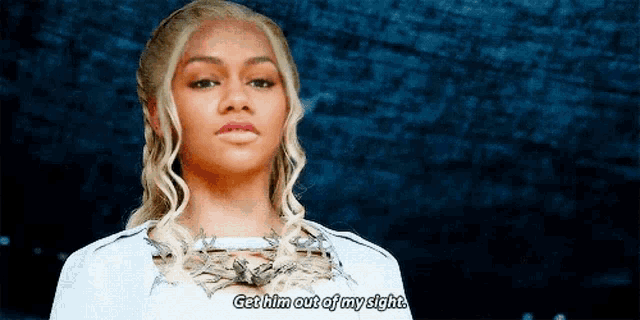 a woman in a white dress is talking to someone and says get him out of my sight .