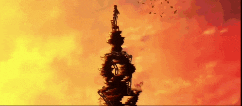 a silhouette of a person standing on top of a very tall building