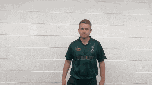 a man in a green shirt with the number 13 on it