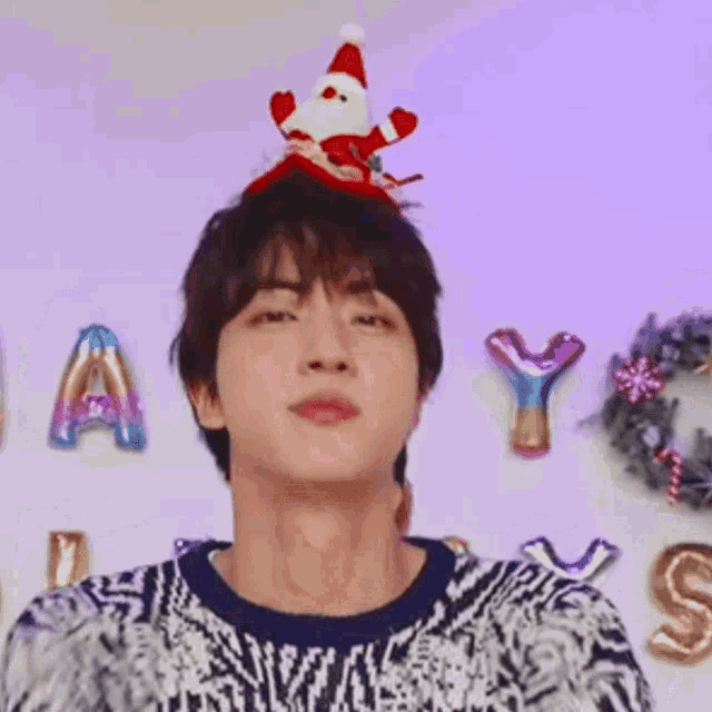 a close up of a person wearing a santa hat on their head