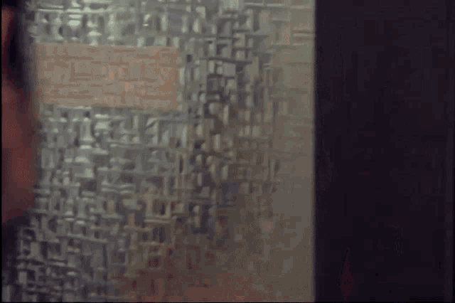 a woman stands in front of a red fire extinguisher