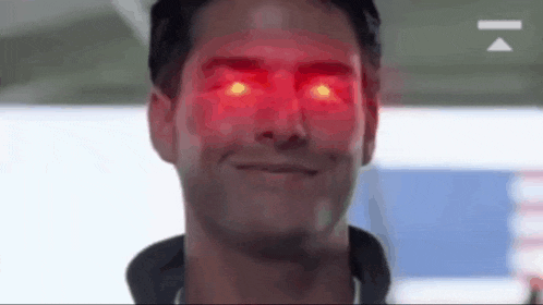 a close up of a man with red eyes .