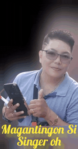 a man is holding a cell phone and giving a thumbs up