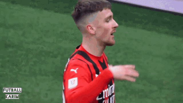 a soccer player in a red jersey with the number 16 on it