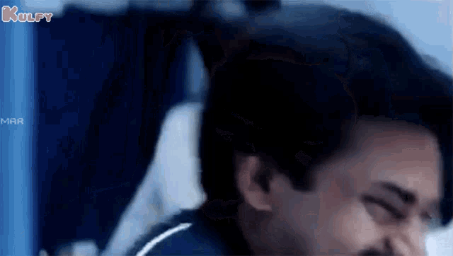 a close up of a man 's face with his eyes closed while sitting in an airplane .