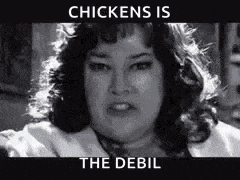 a black and white photo of a woman with the words `` chickens is the debil '' written above her .