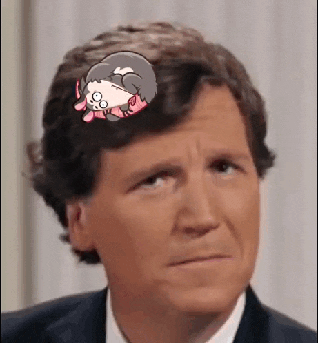 a man in a suit and tie is looking at the camera with a sticker on his head .