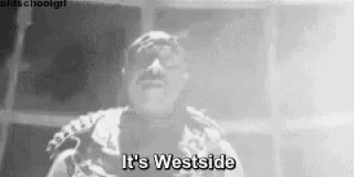 a black and white photo of a man standing in front of a window and saying `` it 's westside '' .