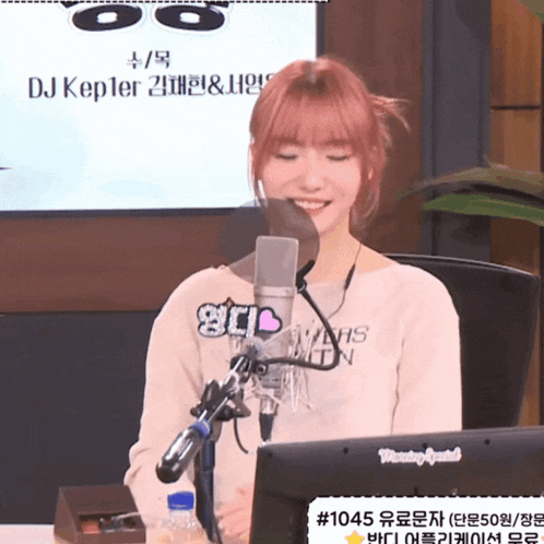 a woman sitting in front of a microphone wearing a shirt that says dj kepler on it