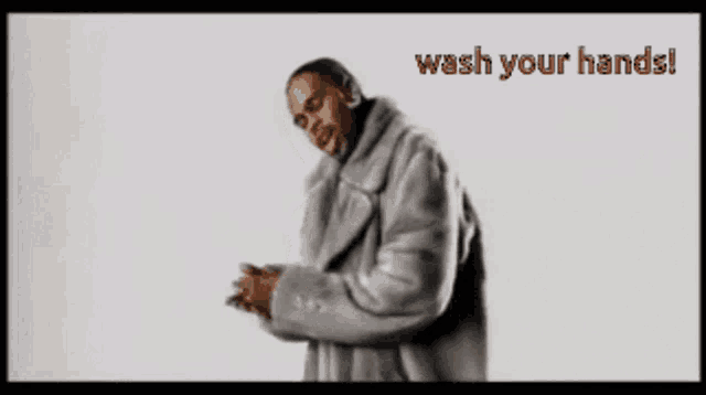 a man in a fur coat stands in front of a white background that says wash your hands