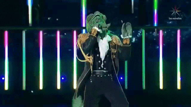 a chameleon in a tuxedo is dancing on a stage