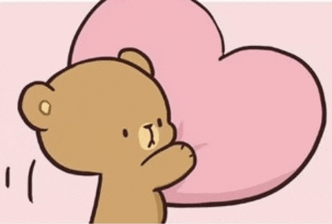 a cartoon teddy bear is holding a pink heart in his hands .