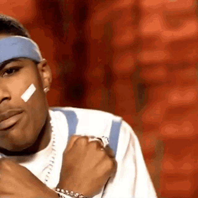 a man with a bandage on his face and a headband