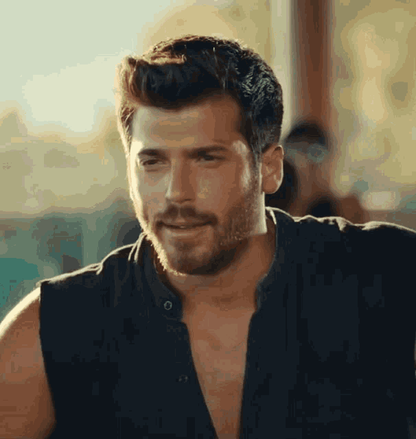 a man with a beard wearing a black shirt