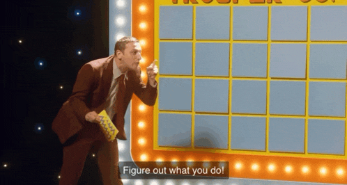 a man in a suit is standing in front of a board that says figure out what you do