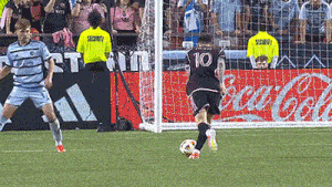 a soccer player wearing a number 10 jersey kicks the ball