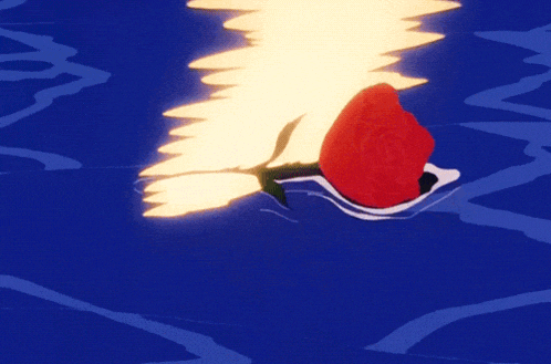 a red rose floating in the water with a yellow light behind it
