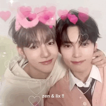 a couple of young men are standing next to each other with hearts on their heads .