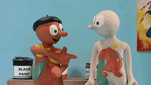 a can of black paint sits on a shelf next to two cartoon figures