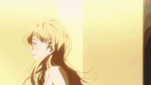 a girl with long blonde hair and a flower in her hair is standing in front of a wall .
