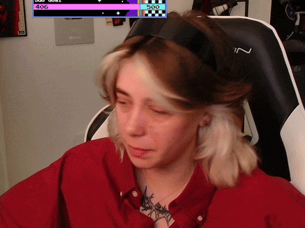 a woman wearing headphones is sitting in front of a screen that says ' 500 ' on it
