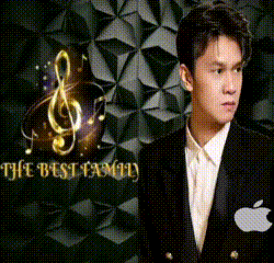 a man in a tuxedo is standing in front of a wall that says the best family