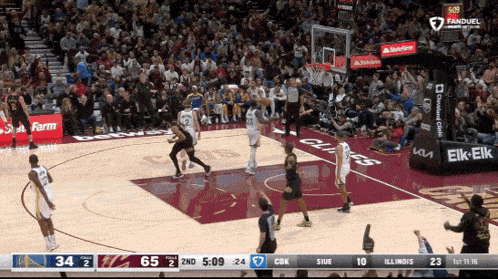 a basketball game is being played in front of a large crowd