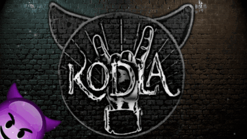 a brick wall with a drawing of a cat with horns and the word koda on it